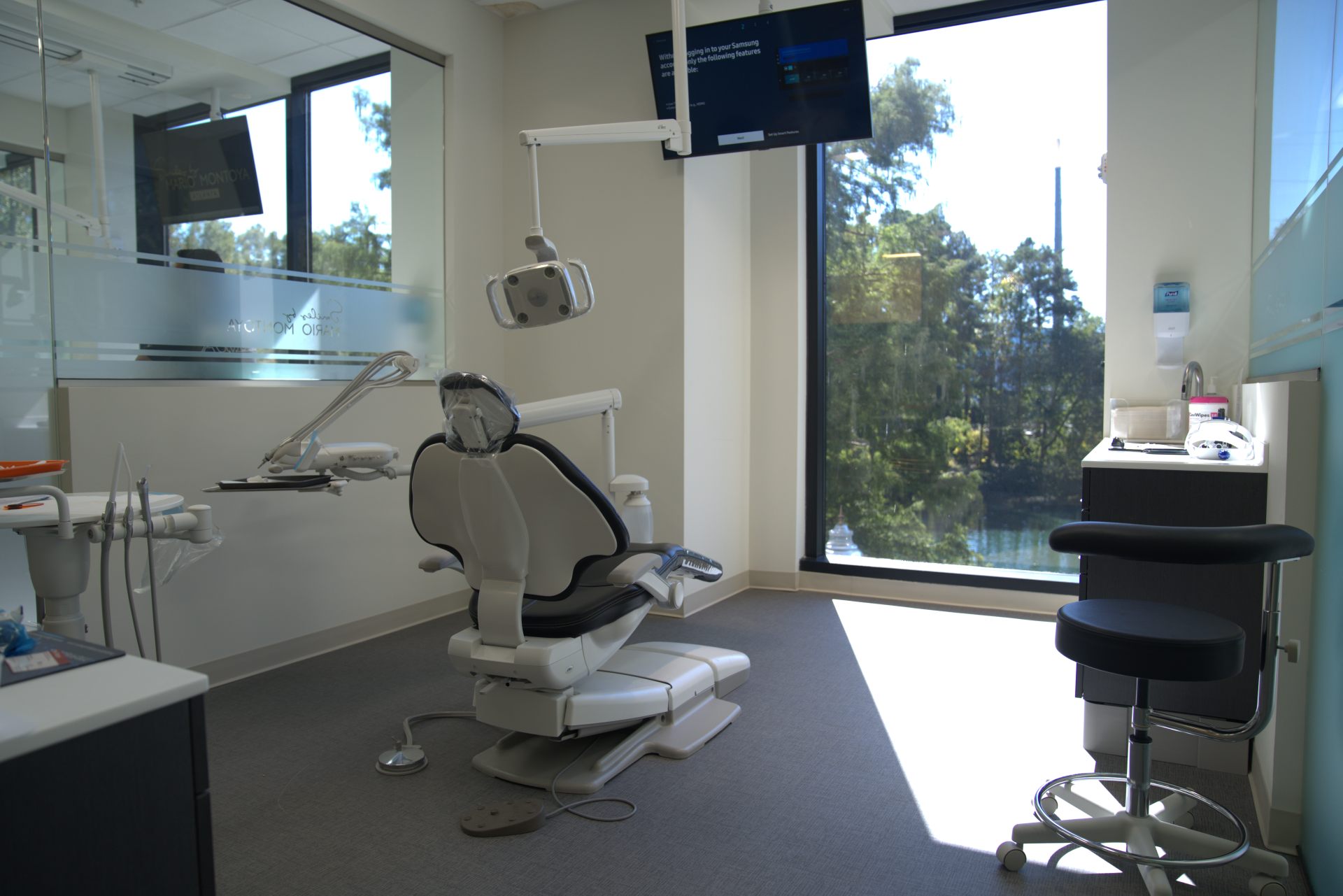 Dental treatment room with a reclining chair and overhead lighting at Smiles by Mario Montoya in Sandy Springs, GA