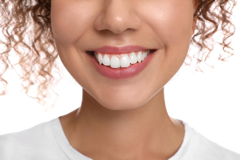 Close-up of a woman smiling brightly, highlighting natural tooth shape and cosmetic smile design
