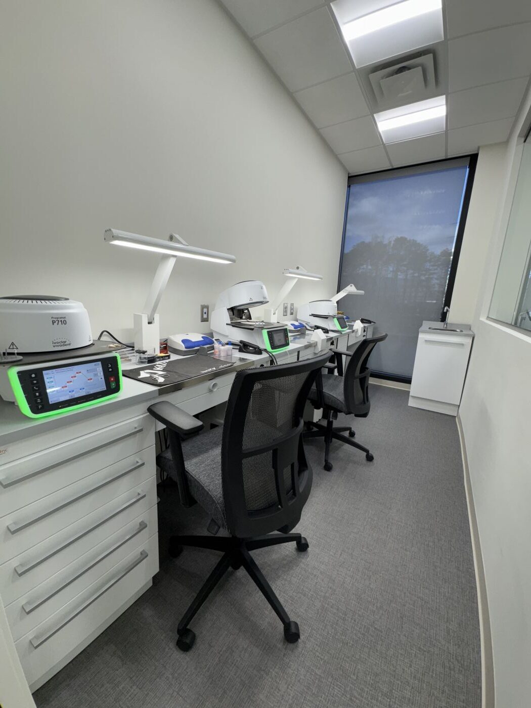 Modern dental treatment room featuring a reclining dental chair and clinical equipment at Smiles by Mario Montoya