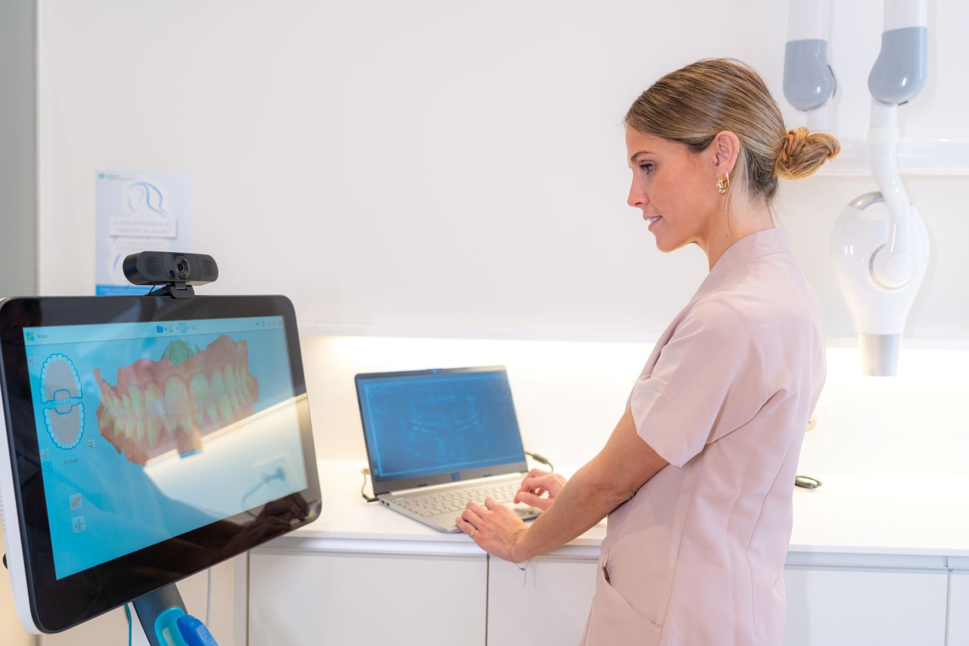 Dental professional reviewing digital dental X-rays on a monitor to support diagnosis and treatment planning
