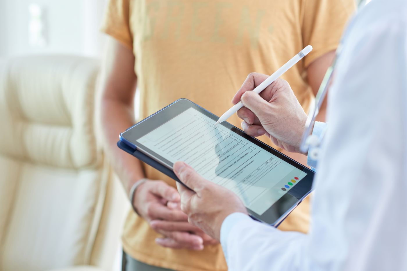 Dental professional using a tablet to review information during a patient consultation
