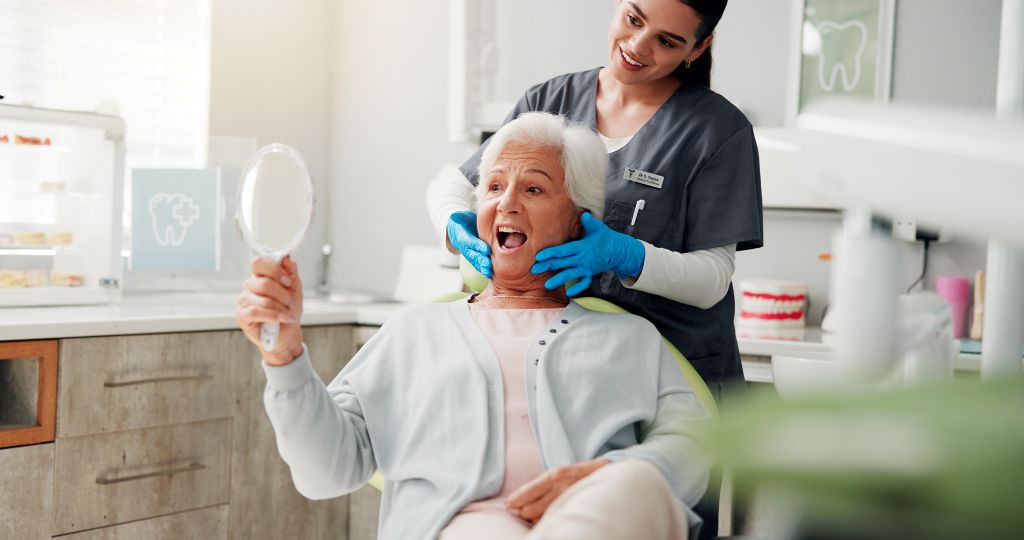 Dental professional providing treatment to a reclining patient during a restorative dentistry appointment